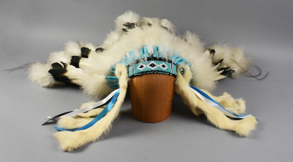 Vintage Native American Hand Crafted Headdress: This is a wonderful vintage headdress, believed to be Navajo or Plains. It is hand crafted, white feathers with black tips, attached using turquoise blue threads, hand beading along the forehead of tu