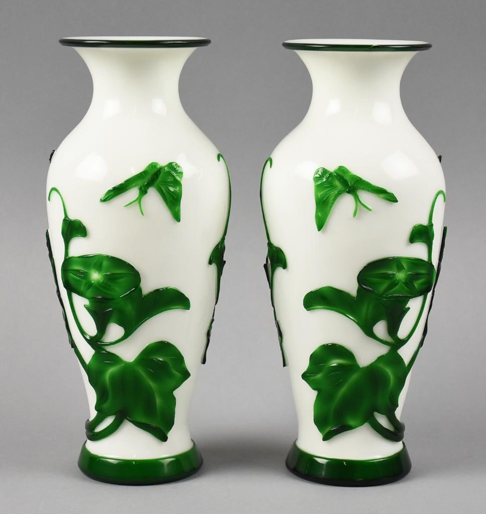 Vintage Chinese Peking White w/ Green Overlay Vases: Gorgeous pair of Chinese Peking glass vases. White glass with rich green overlay of leafy vines and butterflies. Accented in the same rich green around base and rim. No visible marks and stand approx.