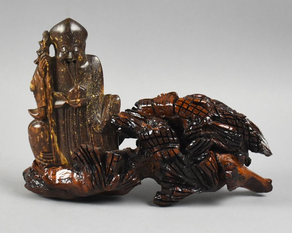 Vintage Chinese Hand Carved Shou Lao, Hardwood: Very cool vintage hand carved Chinese God in hardstone, sitting on wood which appears in the form of a pine tree. Carving is the God of Longevity, Shou Lao, smiling and holding a staff. Measures