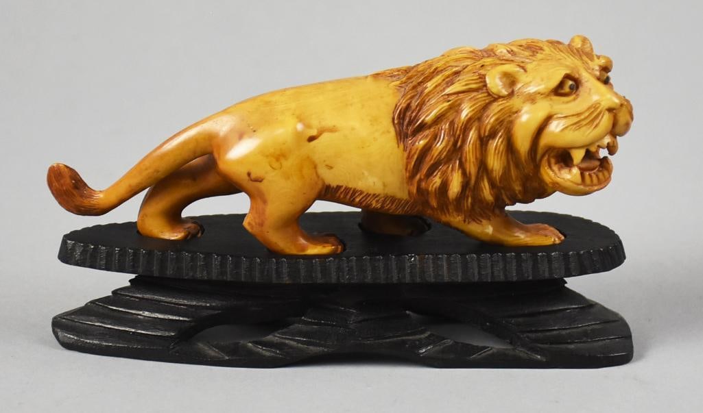 Vintage Chinese Hand Carved Boxwood Lion on Stand: Very nice vintage carving from China. It appears to be a lion and hand carved in boxwood. It is on a custom stand with cuts to fit the feet. Meausrs approx. 3" x 6".