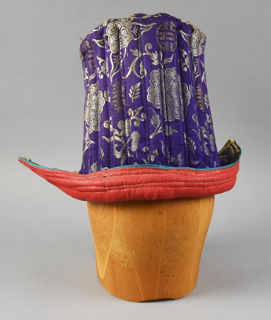 Antique Tibetan Buddhist Ladakh Purple Silk Quilted Hat: This is a terrific hat from the Ladakh region of India. The Tibetan hat or tipi is purple silk with good luck symbols embroidered. It is quilted and lined with red fabric. Appears hand sewn. Measures 