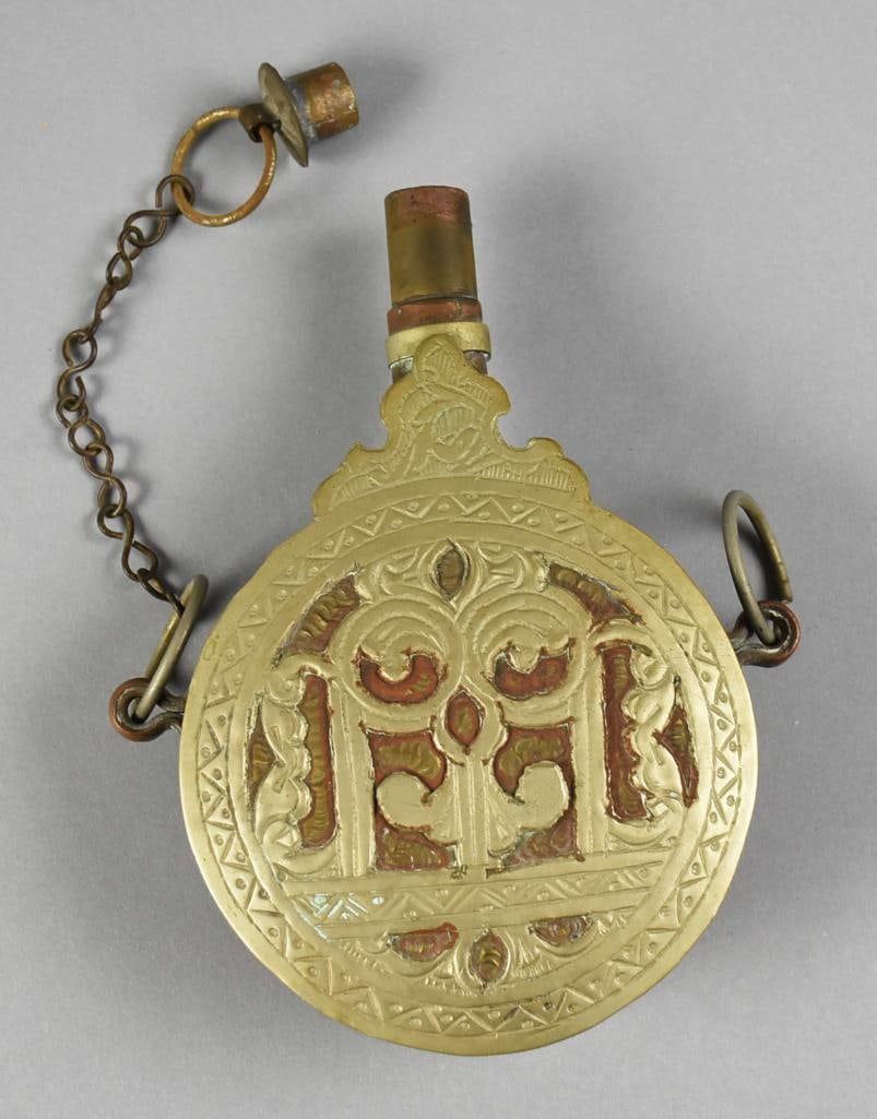 19th Century Islamic Brass Powder Flask: This is a terrific antique that appears to be from the 19th century. Brass powder flask is Islamic with impressed stars, scrolls and geometric lines, all appearing hand created. Loops on each side, on
