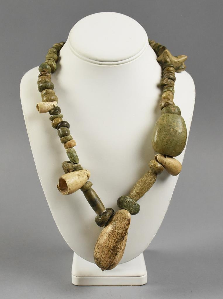 Pre Columbian Western Mexico Stone Necklace: Wonderful pre-Columbian necklace, likely from between 200 BCE and 800 BCE. Beads are hand carved and appear jade or quartzite. The larger bead pendant is carved and appears to be a shell. Measures app