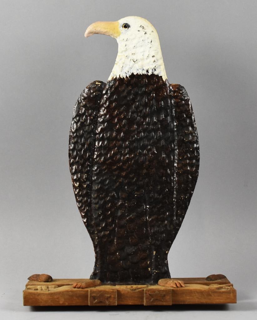 Vintage Folk Art Eagle, Metal & Wood Sculpture: Description: This unique American folk art sculpture features a striking, double-sided hammered metal eagle with detailed hand-painted accents. The eagle is expertly mounted on a handcrafted wooden