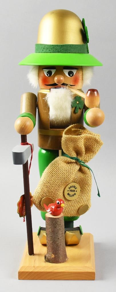Vintage German Steinbach Scottish Leprechaun Nutcracker: This is a fun nutcracker from Steinbach in Germany. He is a Scottish Leprechaun with pipe and burlap bag with a Double Your Millions. He retains the original label and stands approx. 16" tall.