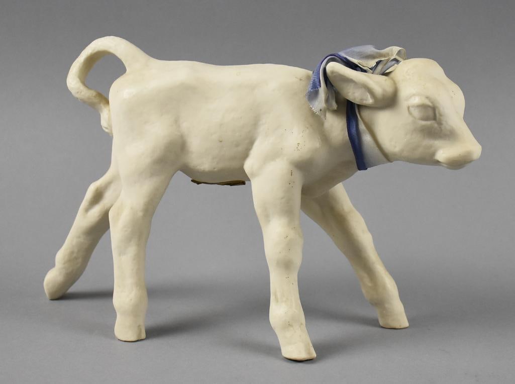Antique Hutschenreuther Selb Porcelain Calf Figurine: Very precious antique Hutschenreuther Selb figurine. Sweet figurine in the form of a calf with a blue silk or satin ribbon around it's neck. Retains the original paper label, stamped on one hoof. Meas