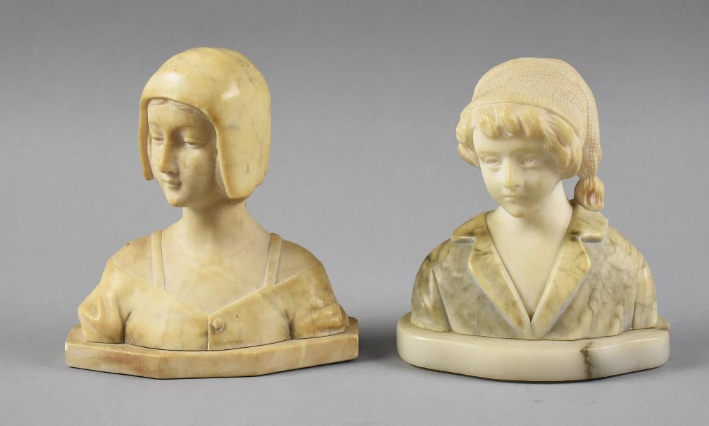 Vintage Alabaster Portrait Bust Figures: Darling pair of portrait busts in what appears to be alabaster. Each is of a young girl. One wears a Dutch style bonnet, one wears a had scarf. No visible marks, bases appear marble.?