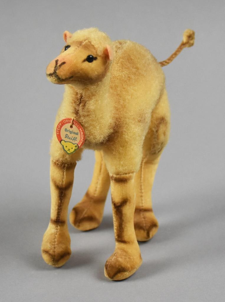 c1950 German Steiff Mohair Dromedary, Original Tag: This darling toy is from Steiff and made in Germany. He is 1950s vintage dromedary with a mohair body and velvet face and legs. He retains his original paper tag and measures approx. 6" x 6".