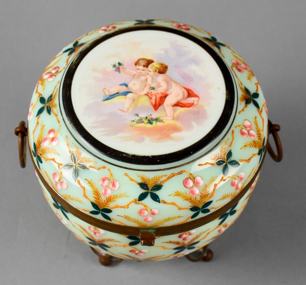 Victorian French Opaline Uranium Glass Jewelry Casket: Gorgeous jewelry casket that is believed to be of French origin. Opaline glass with hand painted cherubs floating in the clouds on the lid. Body is hand painted enamel leaves and berries on gold
