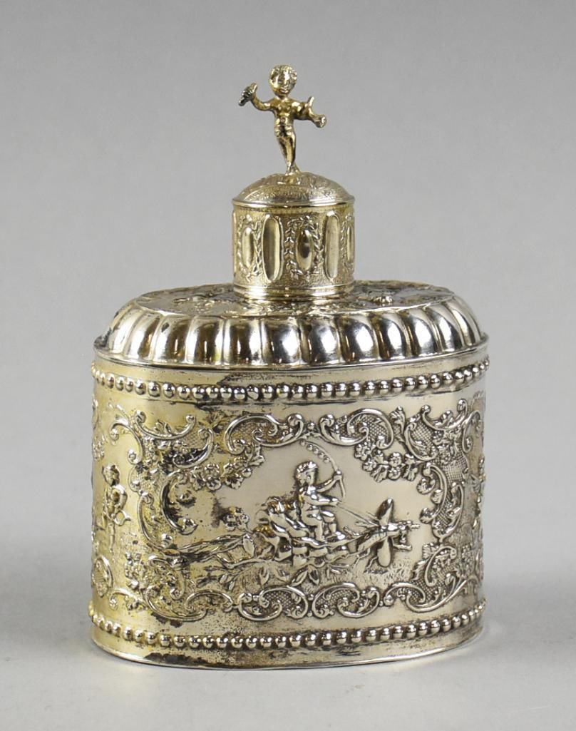1897 .833 Silver Dutch Repousse Cherub Tea Caddy: Fabulous antique .833 silver tea caddy from the Netherlands. It is a beautiful repousse pattern, lid with cherub finial and body with a cherub riding a dragon fly and using a branch of berries as a