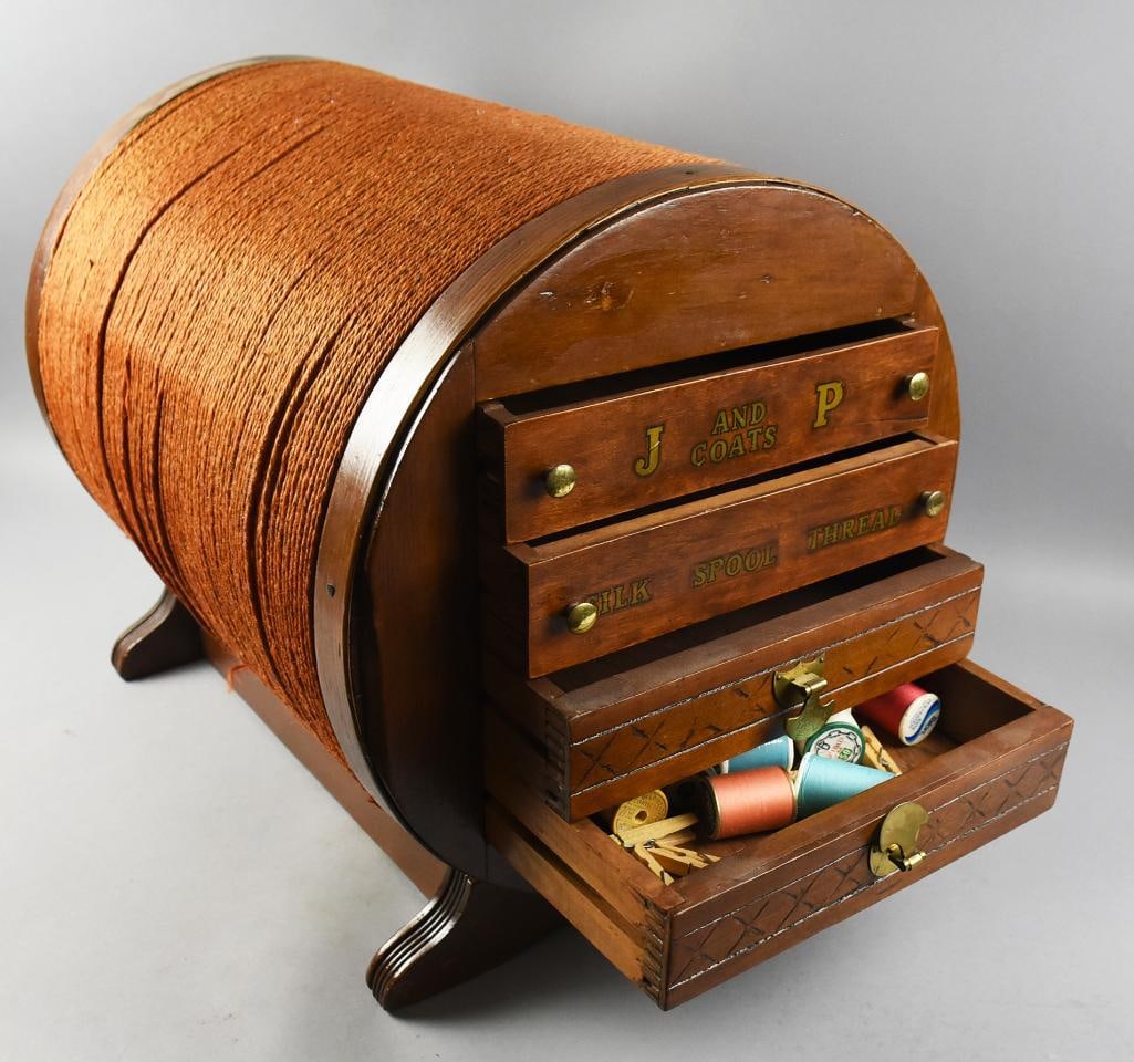 c1900 J & P Coats Spool Thread Cabinet: This is a wonderful antique thread cabinet for J & P Coats. It is spool or barrel shaped and wrapped in what appears to be twine giving the cabinet a spool of thread look. Transfer details on front