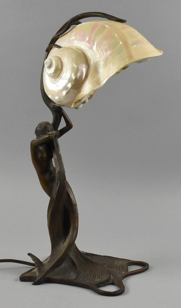 Art Nouveau After Gustav Gurschner Nautilus Bronze Lamp: This gorgeous lamp is Art Nouveau and appears bronze. The lamp is an After Gustav Gurschner, mermaid wrapped around a vine, originally called Nautilus. The conch shell shade appears original and held