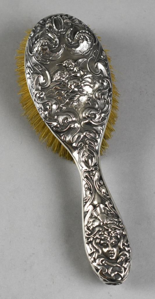 Art Nouveau Unger Brothers Sterling Love's Dream Brush: This is an absolutely gorgeous brush from Unger Brothers. Art Nouveau with cupid kissing a woman, surrounded by clouds and ornate scrolls details. Marked along the side, measures approx. 10" long.