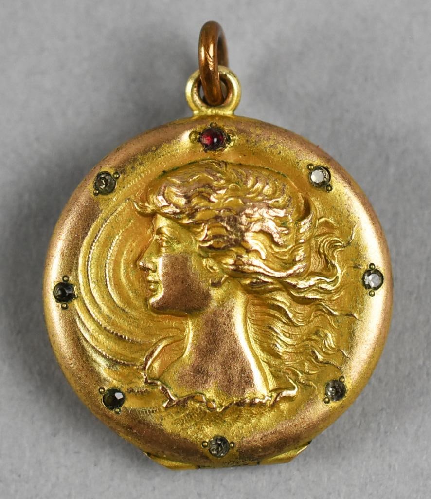 Art Nouveau 14K Rolled Gold & Gemstone Locket: Gorgeous antique locket is rolled gold. Art Nouveau woman on front and back with front being inlaid with clear and ruby colored faceted stones. Weight is approx. 6.4 grams.