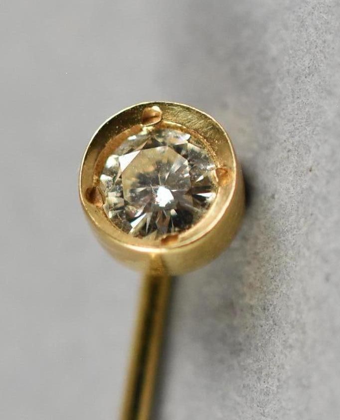 Vintage 14K Yellow Gold & Diamond Stick Pin: Wonderful vintage stick pin in 14K yellow gold. Round top set with a 1/4 carat round cut ring. Stamped 14K on pin and what appears to be the copyright symbol and designer mark. Illegible. Measures