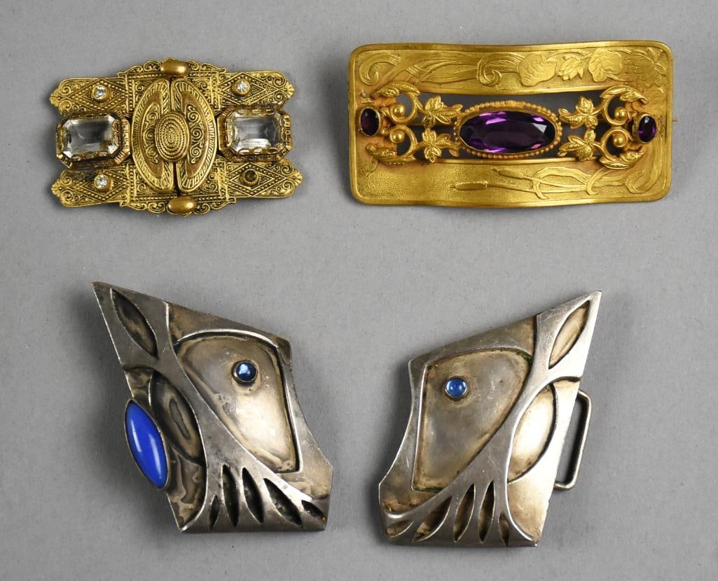 Antique Brooches Art Nouveau Belt Buckle: In this lot you will get an Art Nouveau gold tone sash pin with amethyst color faceted stones, possibly glass, a gold tone with clear faceted glass stone made in Czechoslovakia and a rad modernist