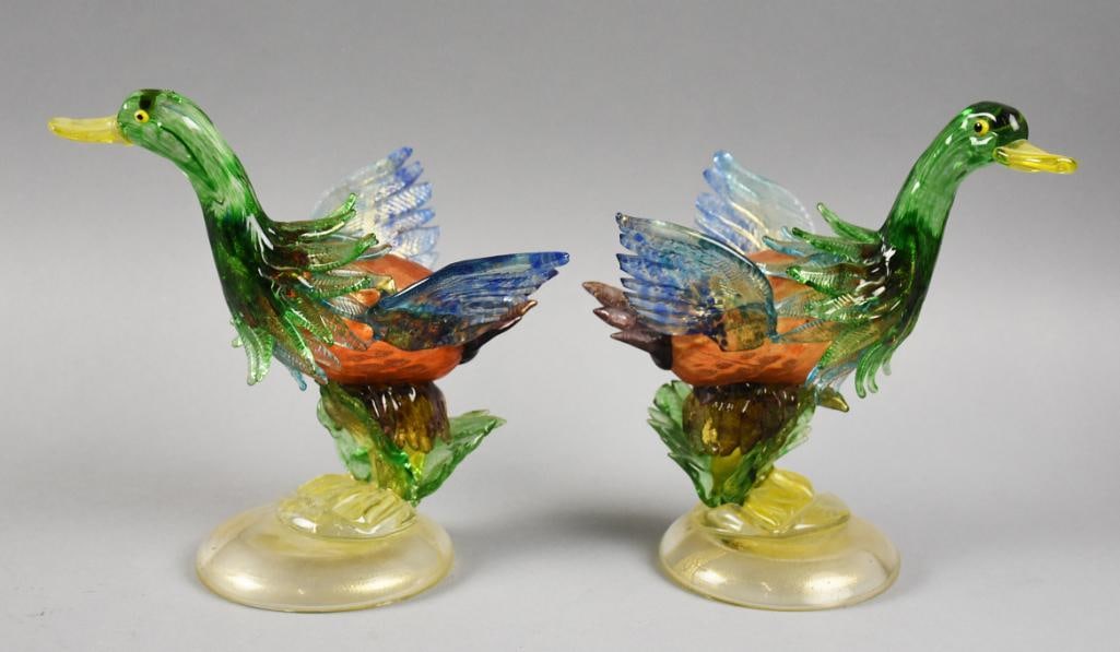 Murano Glass Flying Ducks Figurines Vintage: These are a pair of beautiful vintage Murano ducks. They both appear in flight, green heads, orange with gold fleck bodies and blue wings. They are attached to clear with gold fleck bases. No visible