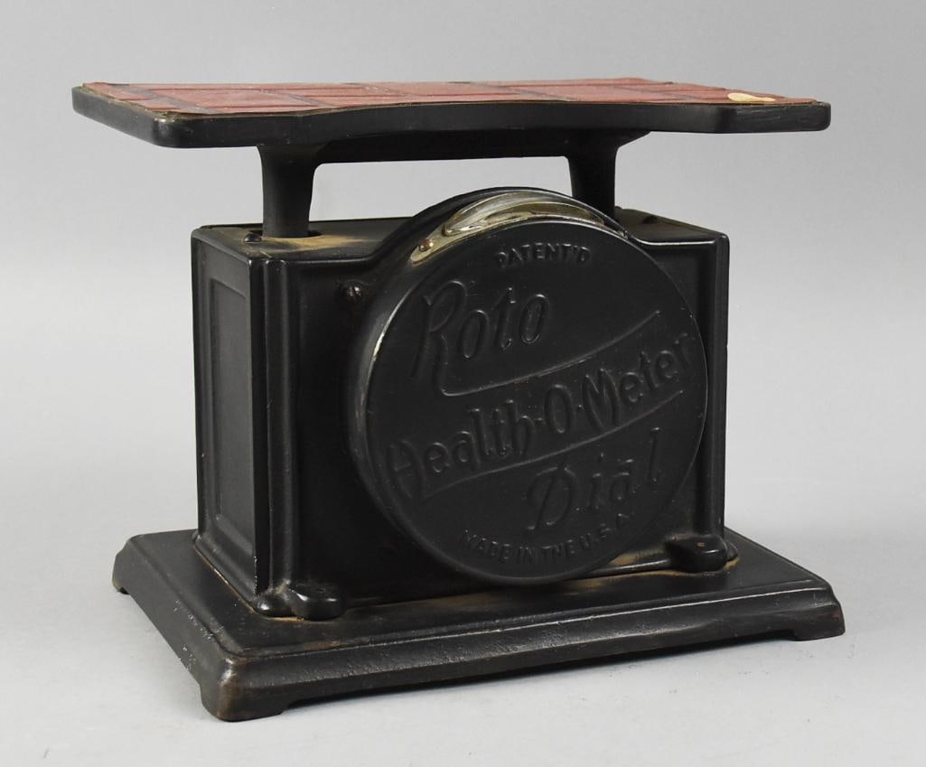 Antique Roto Dial Health-O-Meter Bathroom Scale: Wonderful antique scale known as a Roto Dial Health-O-Meter. It is black with a red brick pattern on the stand. Scale goes to 250 lbs. Numbered on bottom 9-001. Measures approx. 8.5" x 10" x 7". From