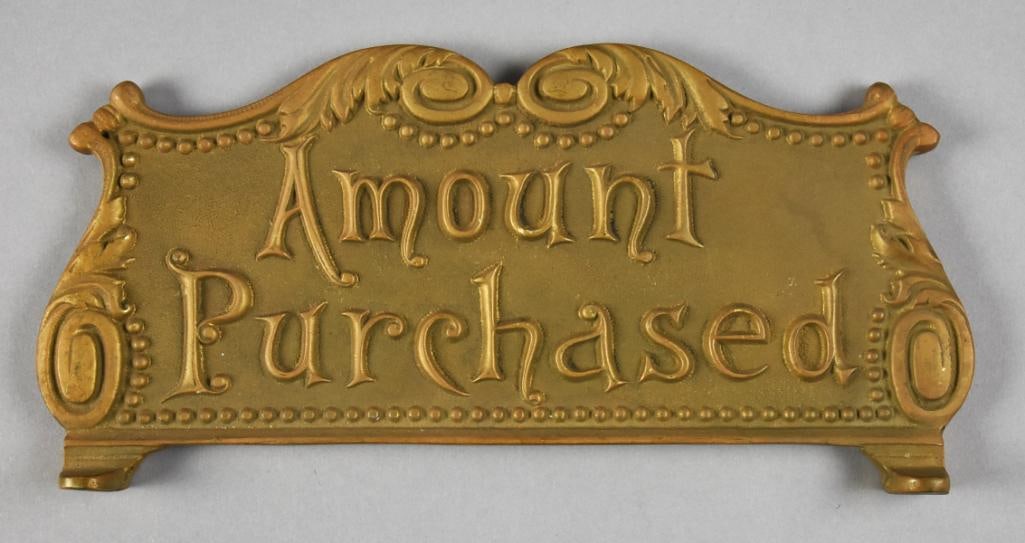 Amount Purchased Brass Register Topper: Wonderful cash register topper in what appears brass. It says Amount Purchased in stylized letters, embossed on both sides. Accented with scroll and acanthus leaf details. Measures approx. 5" x 10".