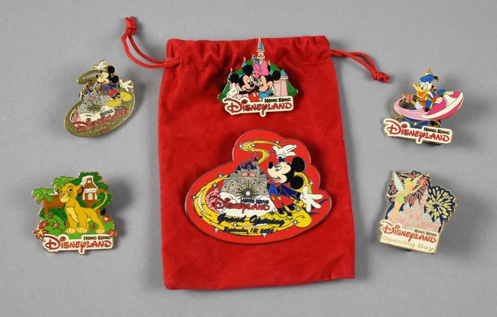 Disneyland Hong Kong Grand Opening Lapel Trade Pins: These fun lapel pins commemorate the grand opening of Disneyland in Hong Kong, Sept. 12, 2005. There are six different pins in total and include the velvet bag as shown.