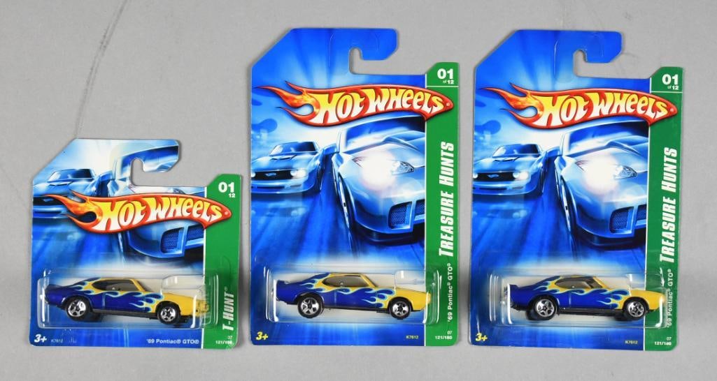2006 Mattel Hot Wheels Treasure Hunt '69 Pontiac GTO MOC NOS: This lot features three Hot Wheels '69 Pontiac GTO cars from the popular Treasure Hunts series, all in original packaging. Treasure Hunts are known for their limited production and exclusive designs. 