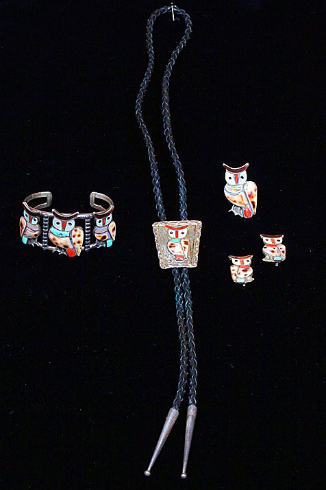 J. Lesansee OWL Jewelry Set: Set consisting of 4 pieces. All pieces have the Owl with inlay shell, Mother of Pearl, abalone, and red stone. BOLO TIE = Leather, 36" long. BOLO, single owl, 1 1/2" x 1 1/4". CUFF 3 owls, 1 1/2" wide