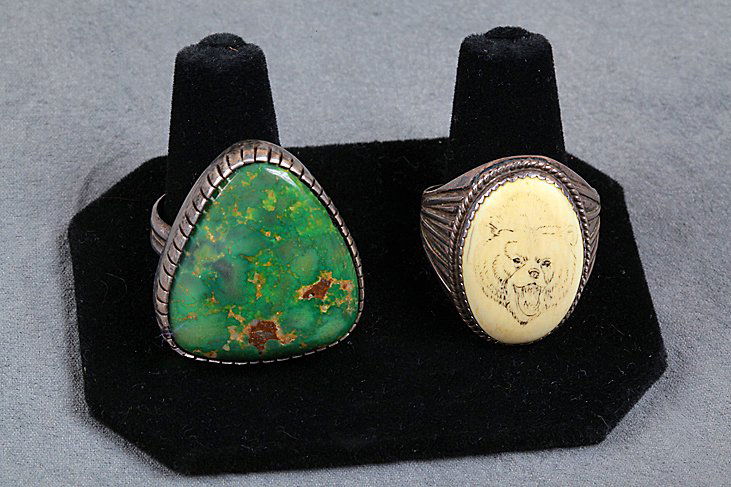 2 Native American Rings: 2 Native American rings set in sterling silver. 1 ring has a triangular green turquoise stone bezel set in sterling, 1 ring has an oval picture of a grizzly bear with it's mouth open, bezel set in ste