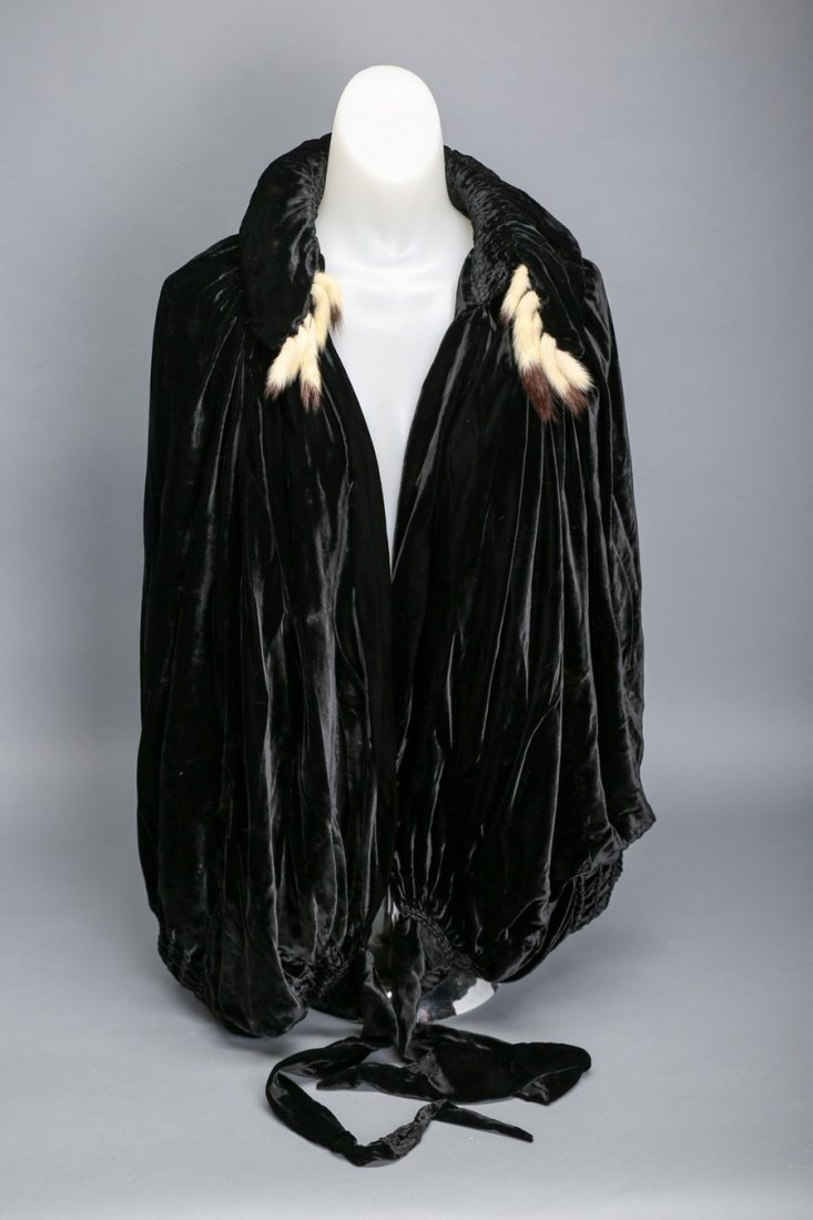 Lanvin c1920 Velvet Opera Coat: Lovely c1920 Jeanne Lanvin black velvet cocoon opera coat. Adorned with ermine tails around the collar, this coat measures 29" across and 25" from collar to hem and ties around the waist. Lining of th