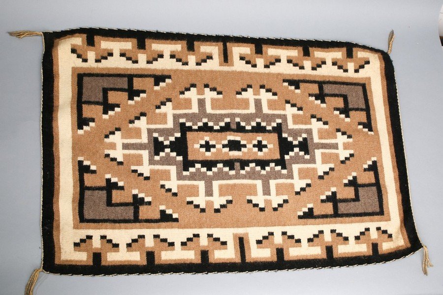 Navajo Blanket Rug Wool: Beautiful antique Native American blanket or rug with brown, black and tan geometric shapes. Has some wear, a few loose threads. Overall in very good condition. Borders in nice shape. Measures 25 3/4
