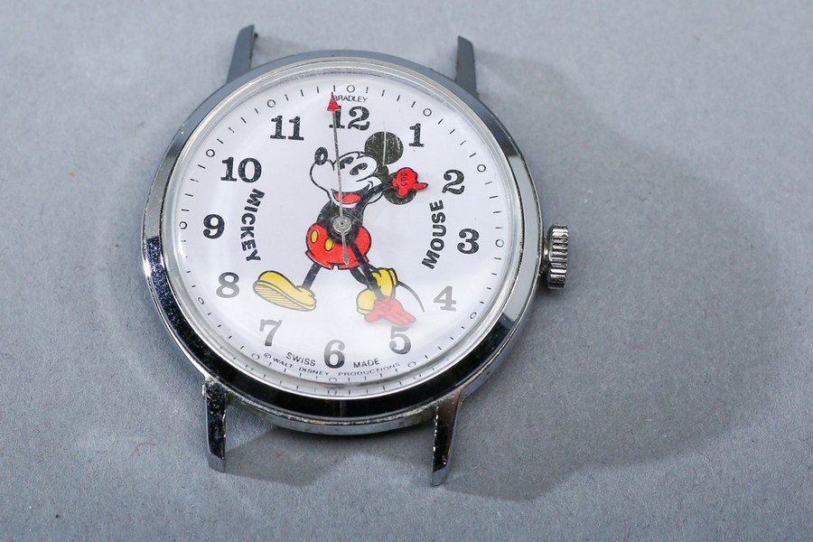 Bradley Pie Eye Mickey Mouse Watch: Vintage mechanical Walt Disney Productions Mickey Mouse Watch by Bradley, marked Swiss Made, Base Metal and is 1 1/4". Condition: Mechanical watch runs and keeps time, Light surface wear to watch, no