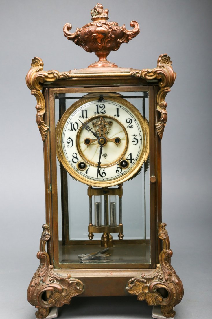 Antique Ansonia Mercury Open Escapement Brass Mantle: Antique Ansonia open escapement mercury mantle clock, brass urn finial, beveled glass, front and back door access, back door has no knob, does have key, needs restoration. Measures 15 x 7 x 5.