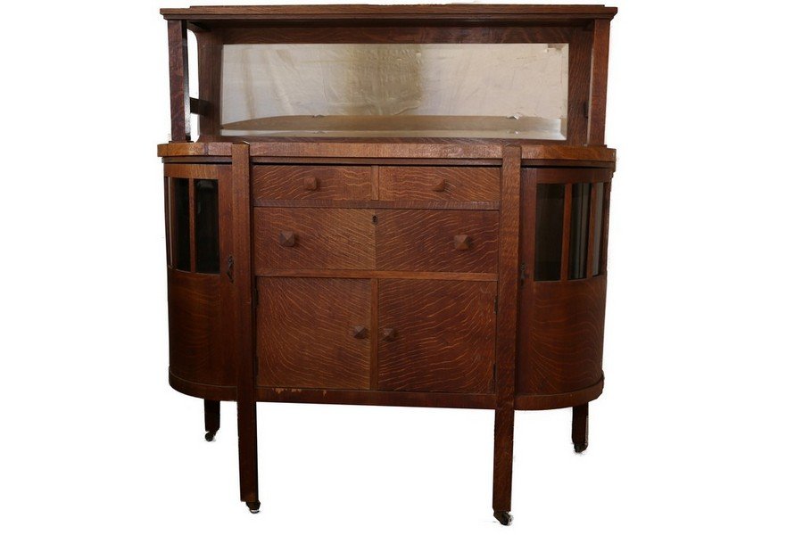 Arts and Crafts Mission Oak buffet: Circa 1900's buffet with glass sides. Has some chipping to verneer. Great piece unusal with the glass curved sides. In good overall condition.