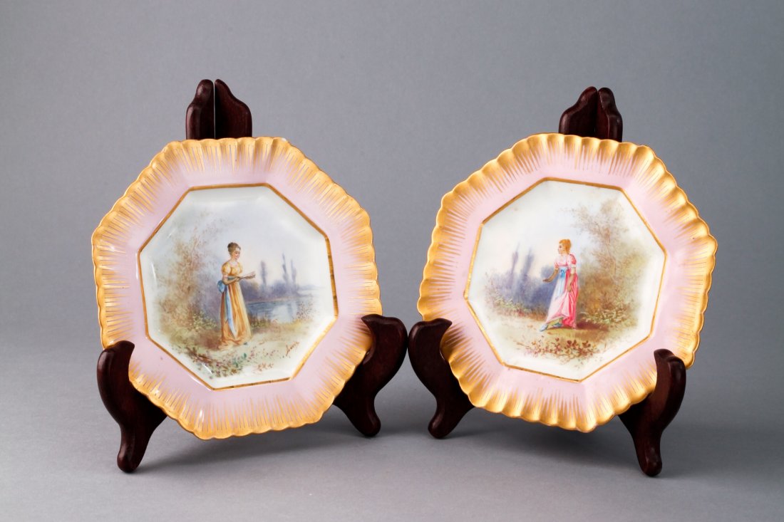Pair 1753 Sevres Lady Plates Signed "Louis": 1753 Sevres plates, ladies walking in wilderness, pink glaze and gold gilt rim. Double L mark, capital A in center in blue, France in red. Each plate is approx 5 3/4". Appears to be in very good condi