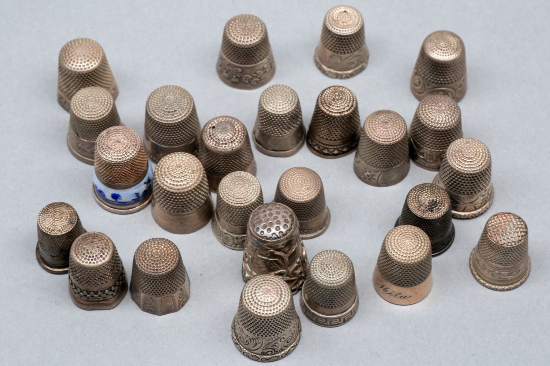 Sterling Sewing Thimbles Lot: Nice lot of 25 sterling sewing thimbles with one having a light gold wash, one having a nice blue enamel design, most marked sterling or 925