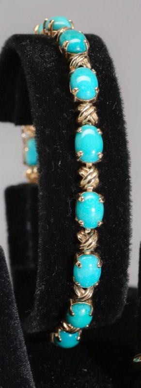 14K Yellow Gold and Turqoise Bracelet: Pretty 14K yellow gold bracelet with 15 cabachon turquoise stones. Bracelet clasp is marked 14K witht the patent 4697315 (Simon Geldwerth, clasp patent) and measures approx 7" long. Weight approx 9.2g