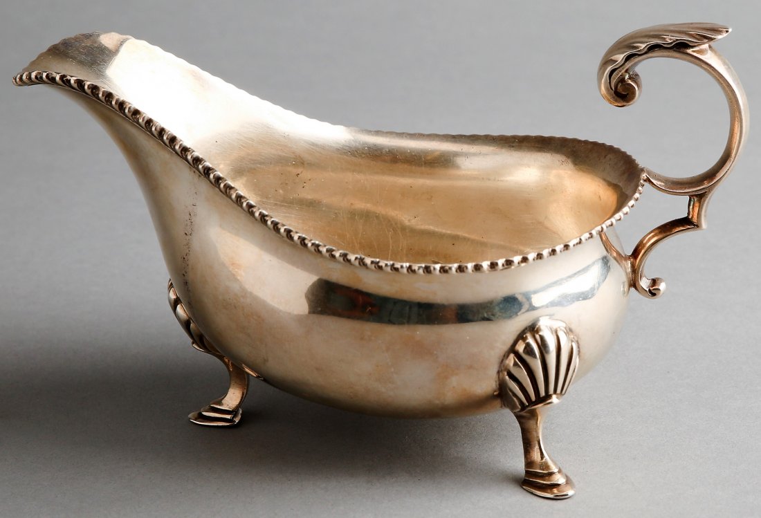 1899 George Hape English Sterling Silver Gravy Boat: Beautiful antique gravy boat in sterling silver. This British sterling piece was made by George Hape, dated 1899. Has clear hallmarks on the back near the handle making it Sheffield from 1899. Measure