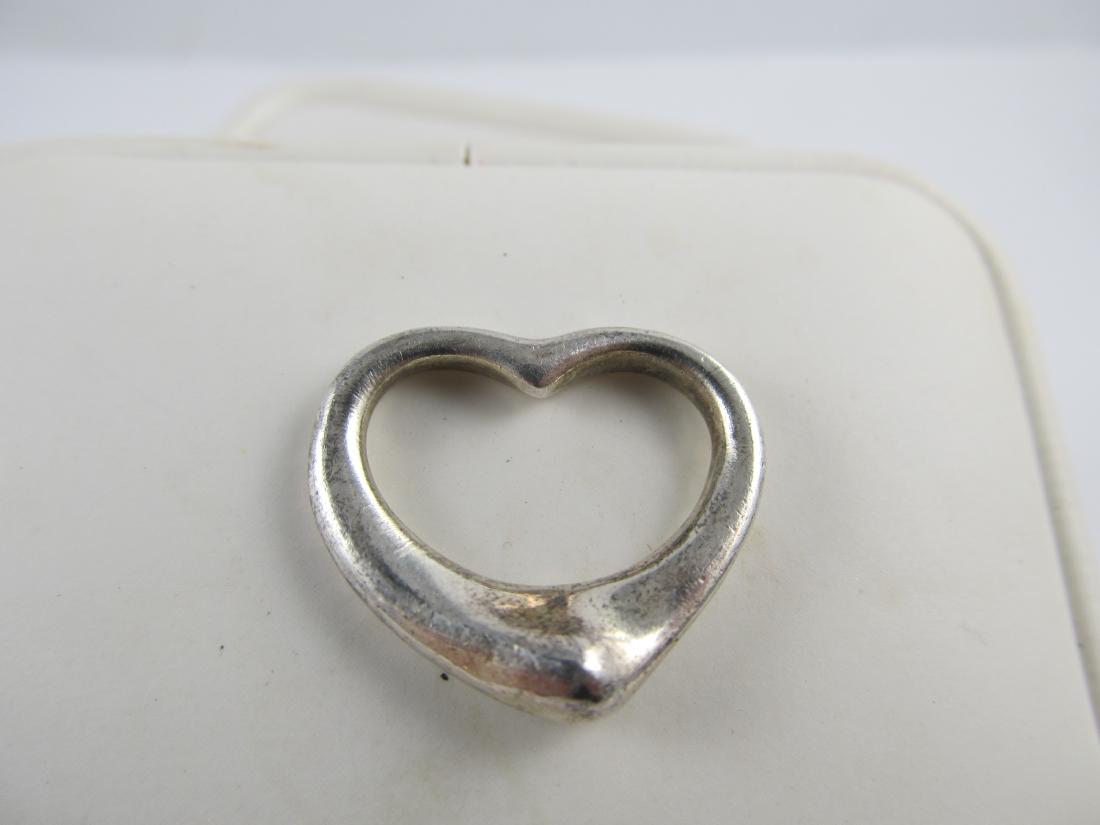 TIFFANY & CO PALOMA PICASSO HEART STERLING SILVER FINE: This attractive Paloma Picasso Tiffany & Co sterling heart pendant or charm is in overall good condition with some slight scratching from being enjoyed. It has a nice patina & should polish nicely.It 