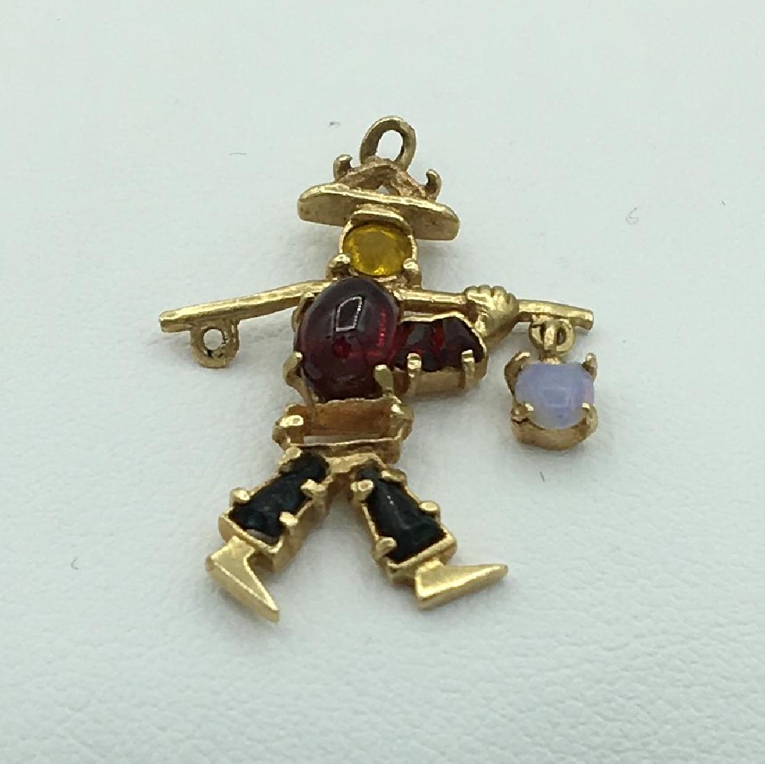 14K Yellow Gold Opal and Garnet Charm of Oriental Water: 14K Yellow Gold Opal and Garnet Charm of Oriental Water Carrier 2.4 Grams. 1.5 dwt. Measures 1 x 3/4 inch 26 x 20 mm. Marked 14K See Photo. Missing Stone and Pole is Bent on Same Side See Photo.