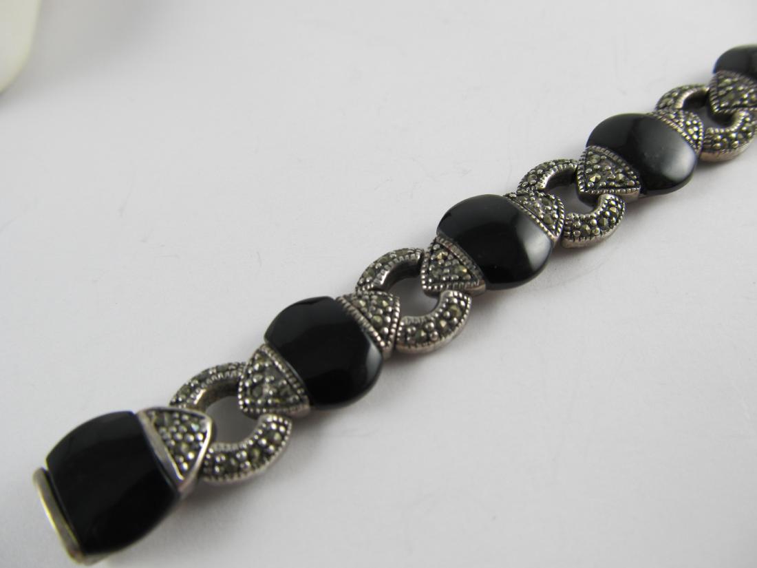 ONYX & MARCASITE STERLING SILVER VINTAGE BRACELET 7 1/2: This is a very wearable sterling bracelet with 9 fine onyx stones and marcasite inlay connectors. It is in overall very good condition with only slight wear. The lock closes nicely. It has an older pa