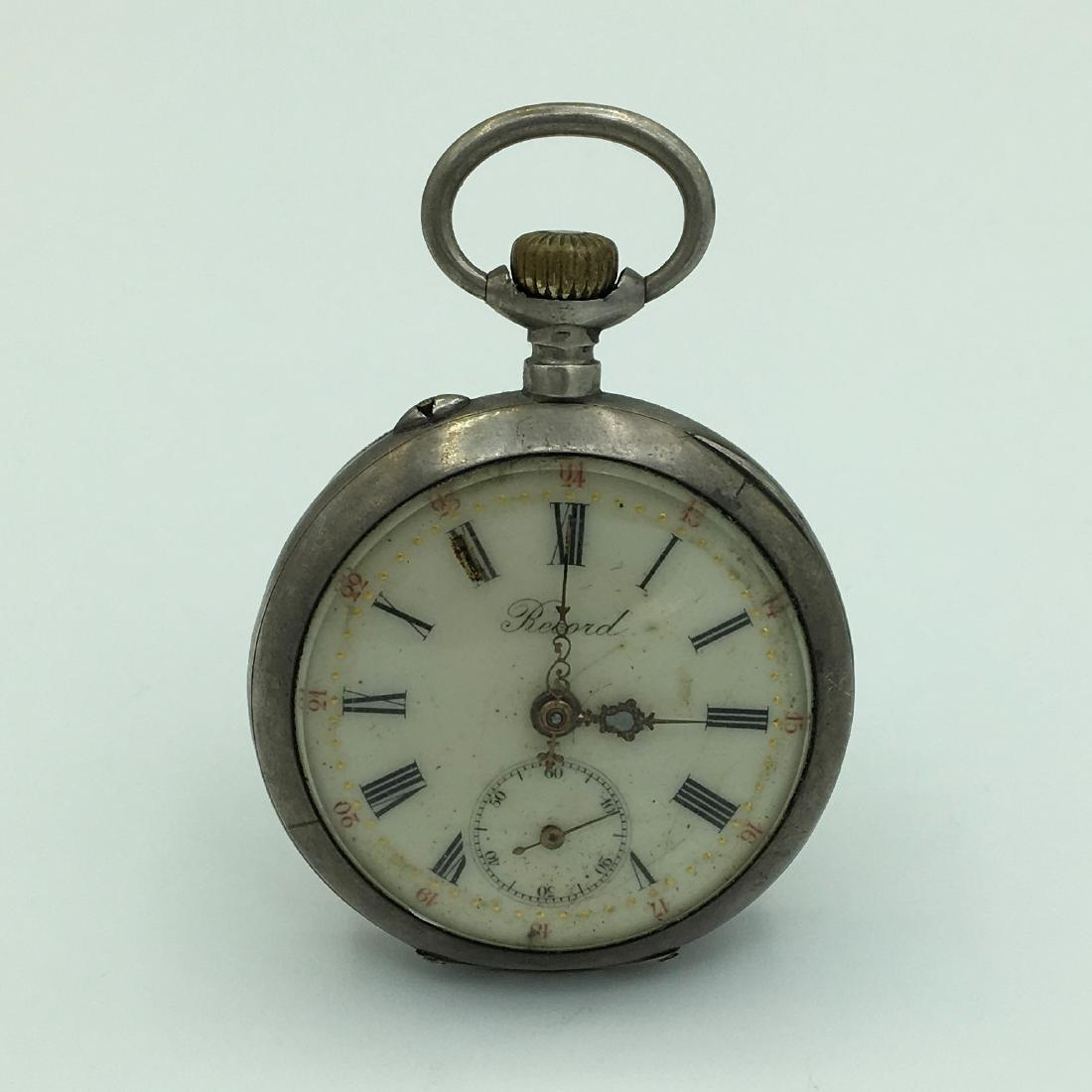 Antique Swiss Record 800 Silver Open Face Sidewinder: Movement has Swiss Copyright BREVET No. 11762. 59.4 dwt. 42 mm Diameter, Engraved Case Back. Hairline on Seconds Dial, Not Running.
