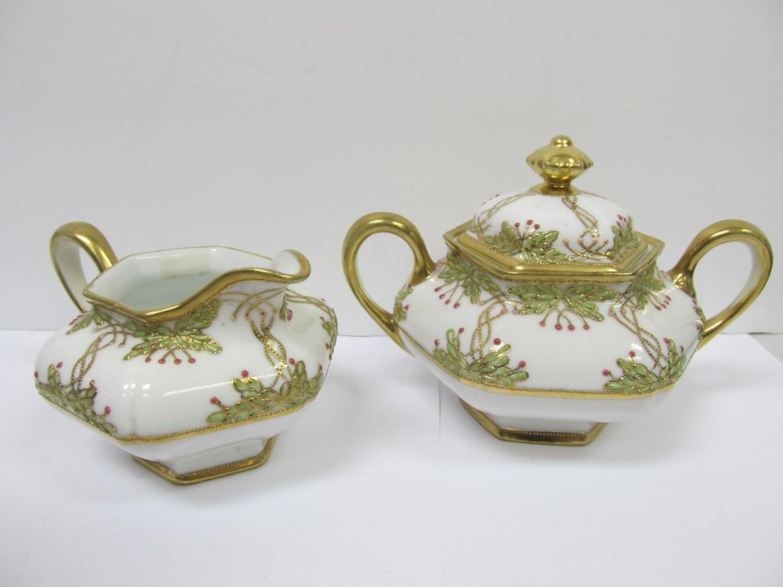 NIPPON JAPAN PORCELAIN LIDDED SUGAR BOWL & CREAMER 4: This beautiful ornately gilded Nippon lidded sugar & creamer is in excellent condition with no nicks or scratching on the bases. There is some very light wear to the handles. They appear to have been 