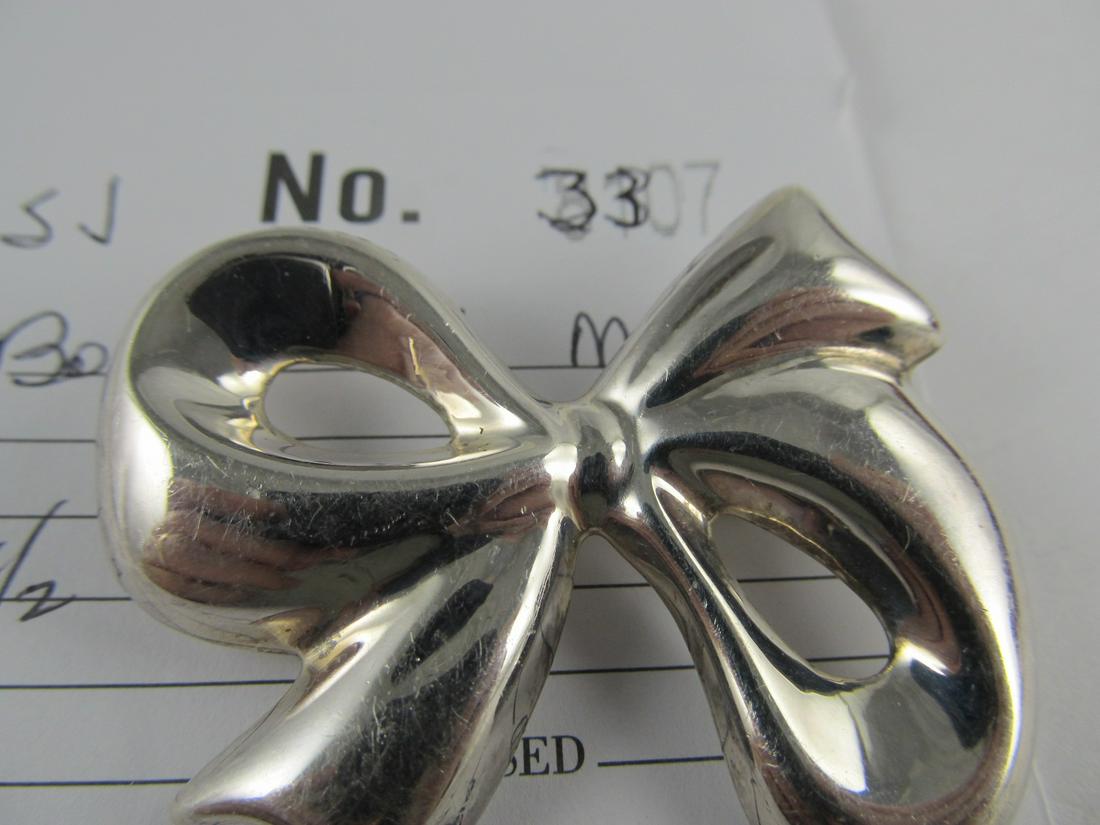 ATI MEXICO BOW PIN STERLING SILVER VINTAGE 1 3/4 H V: This is a very wearable nicely-made bow pin. It is stamped ATI .925 Mexico as shown. It is in overall very good condition with very little wear including a little scratching. It has a nice older patin