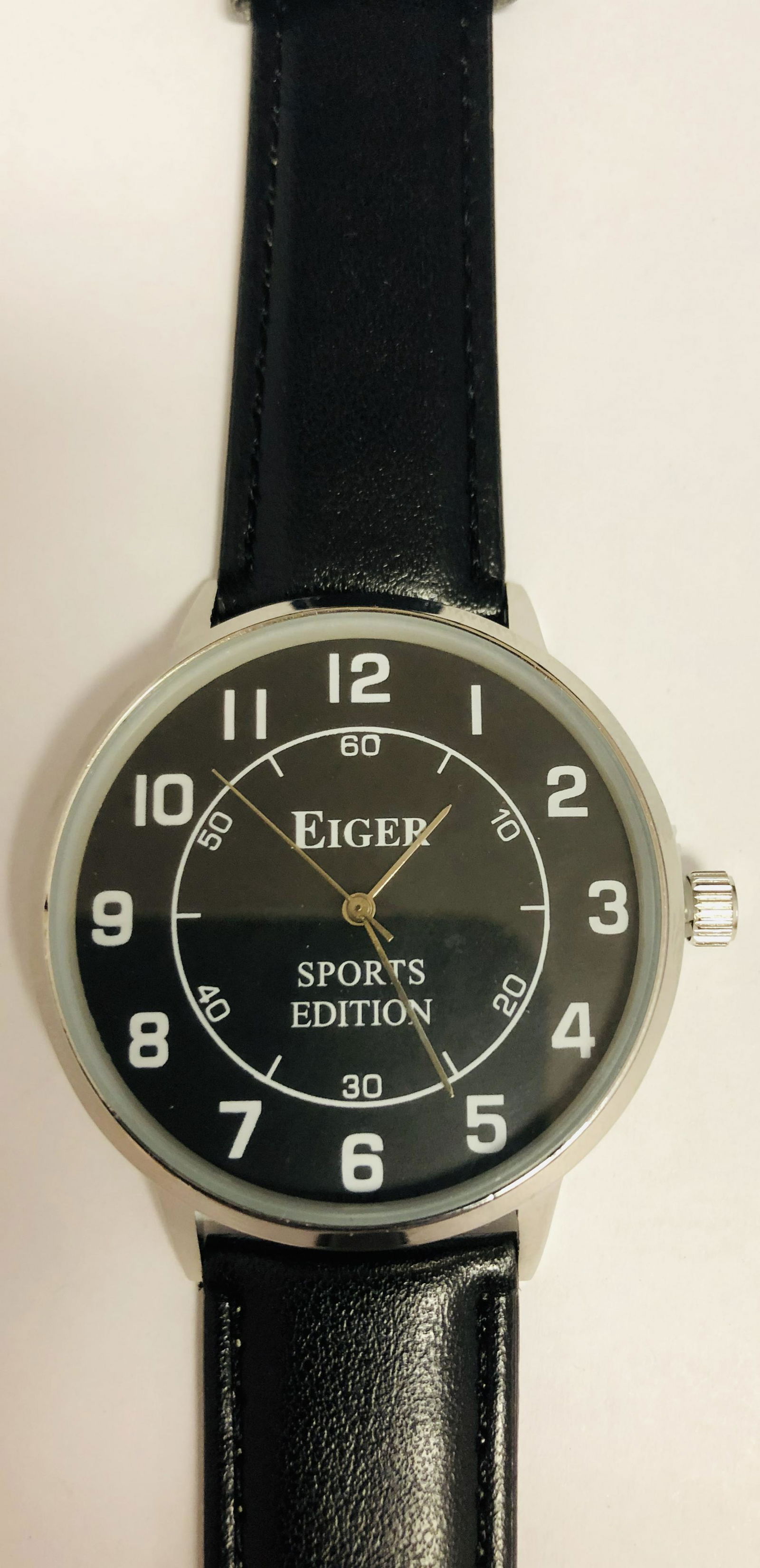 Mens Eiger Sports Edition Watch With Black & White: Mens Eiger Sports Edition Watch With Black & White Dial on a Faux leather band. Watch has a new battery , watch is working and is new in plastic.