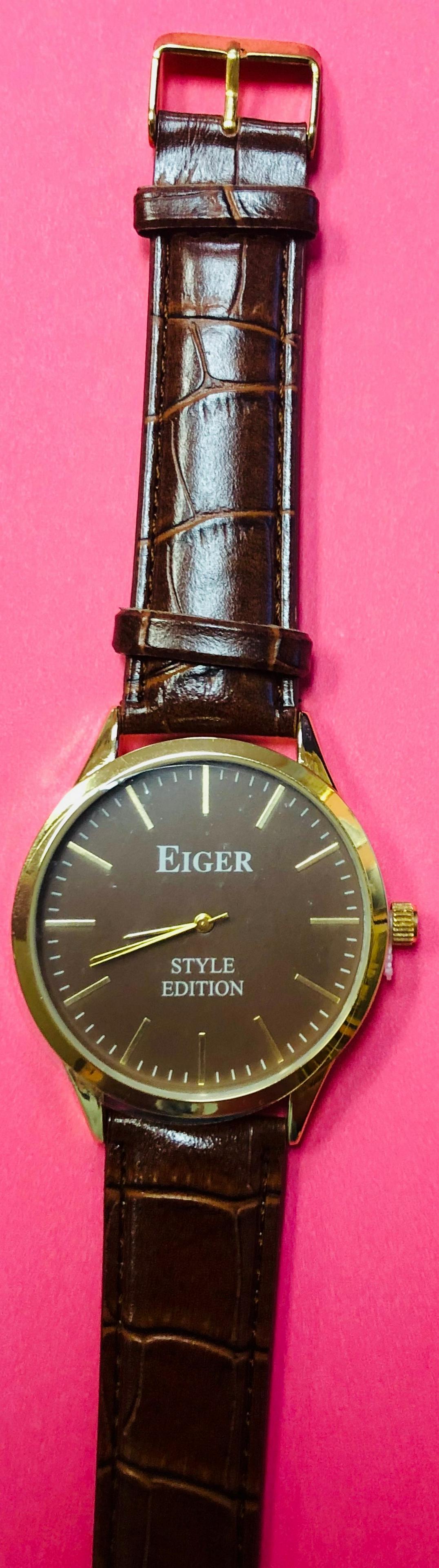 Mens 42 mm Eiger Style Edition Gold Tone Watch: Mens 42 mm Eiger Style edition gold tone watch with a faux brown leather band . Brand new battery and in original wrapping.