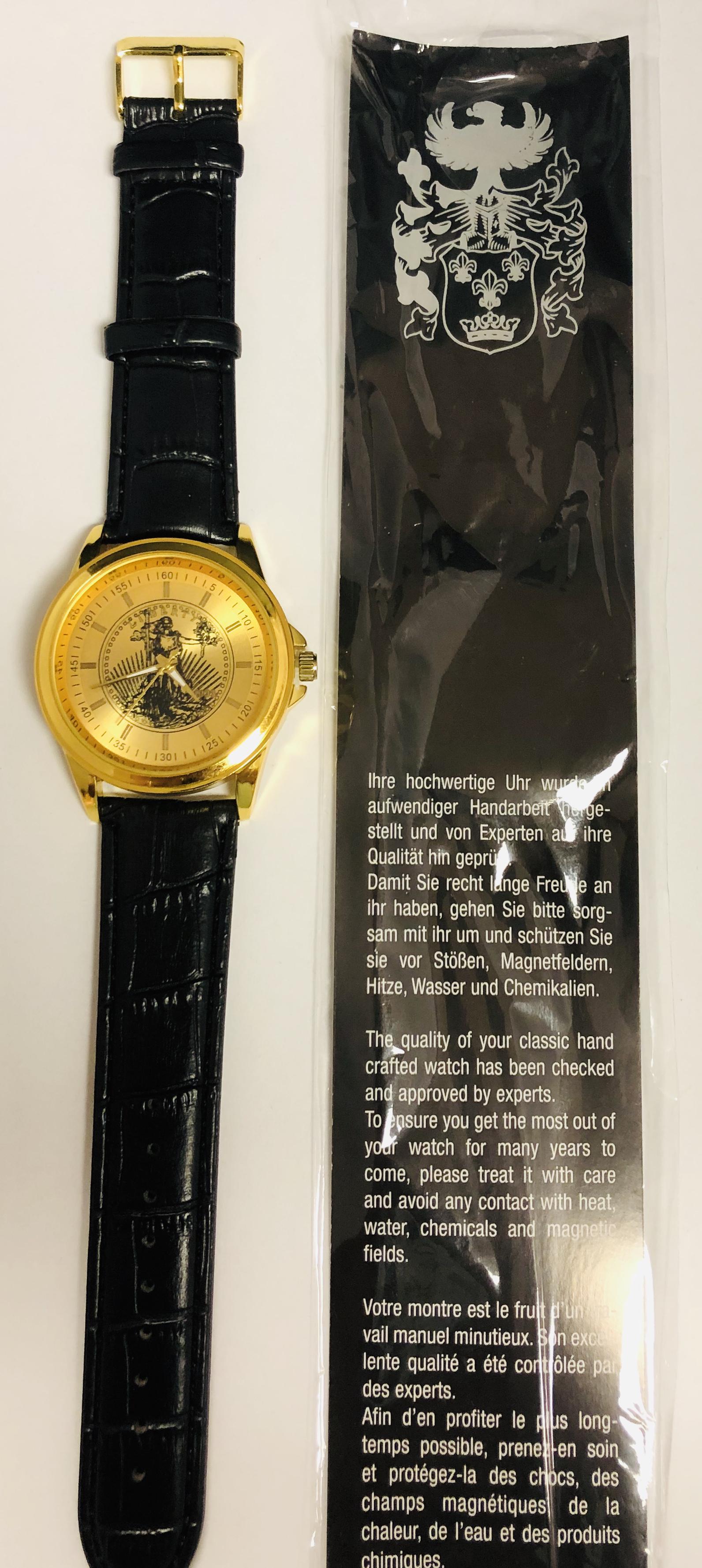 Eiger Liberty Gold Tone Watch With Black Faux Leather: Eiger liberty gold tone watch with black faux leather band and plastic crystal. Watch has a new battery and is in plastic wrapper with paperwork .