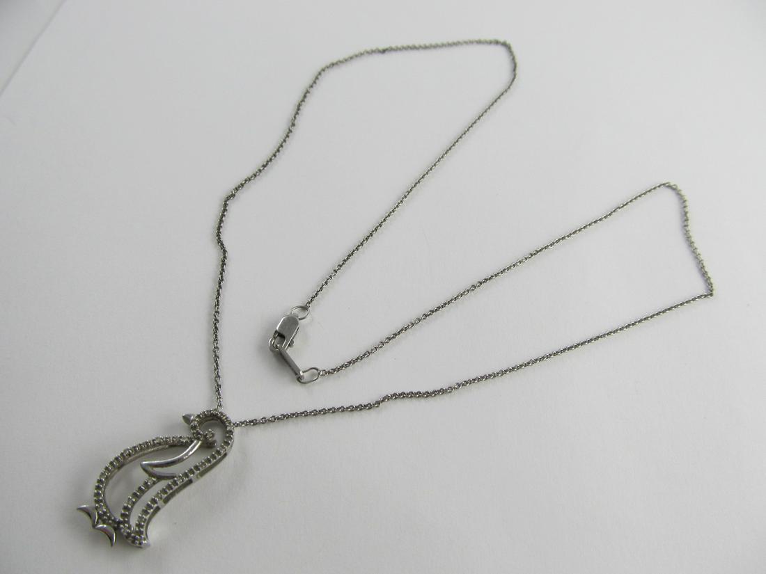 JWBR INDIA PENGUIN MOISSANITE STONES PENDANT / 18" LONG: This very wearable sterling necklace with a fine penguin pendant is nicely made. The lobster lock is stamped 925 sterling & the Penguin also 925. The 2 are in overall very good condition with little w