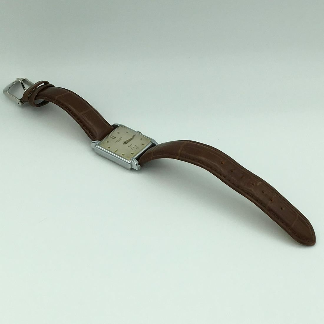 Vintage Universal Geneve Swiss 17 Jewel Unadj Mens: Vintage Universal Geneve Swiss 17 Jewel Unadj Mens Wrist Watch Model 264. Fond Acier Inoxydable Case Measures 25 x 25 mm. 9 Inch Leather Band. Missing Minute and Second Hands, Not Running.