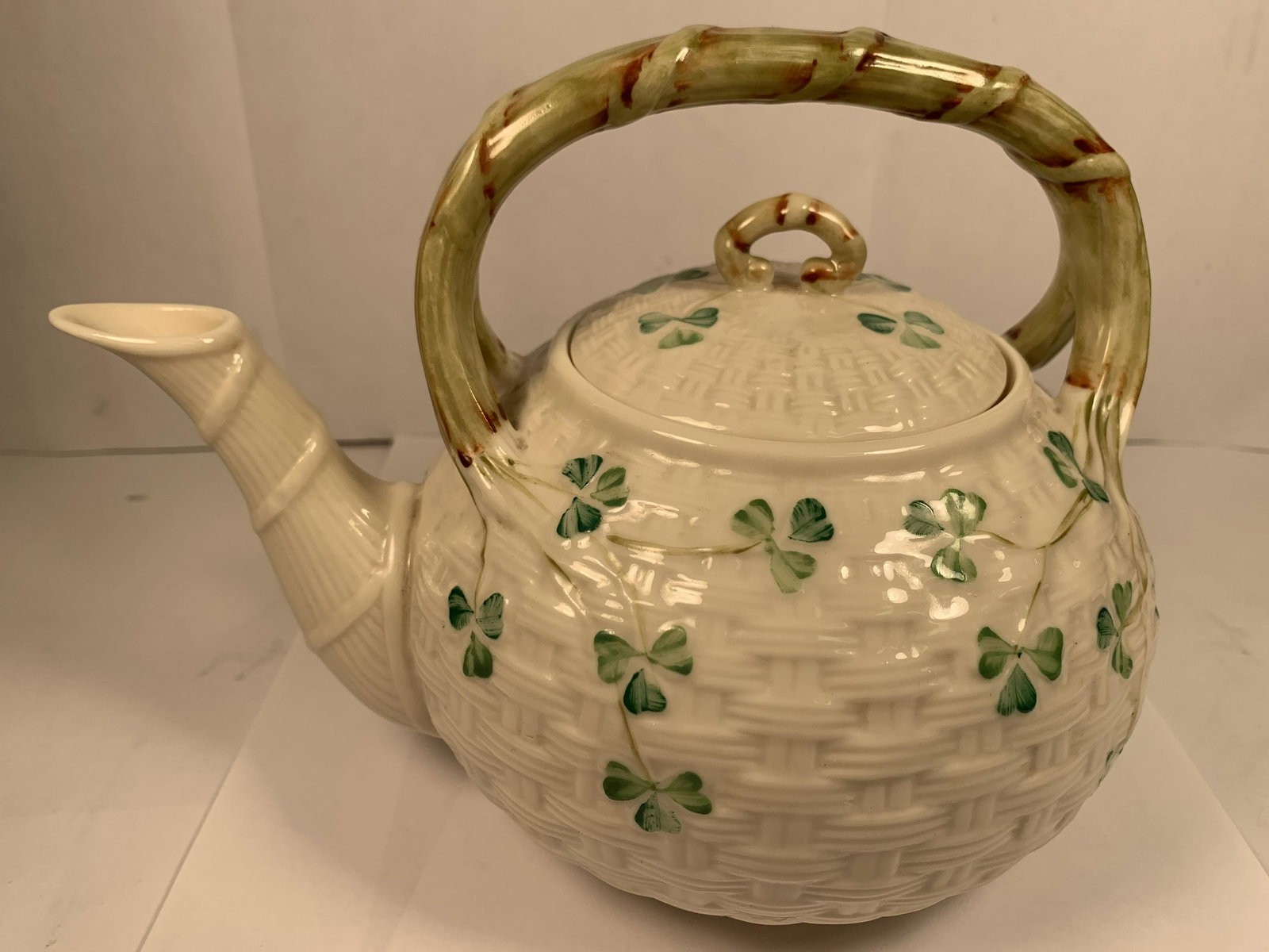 Belleek Shamrock Basket Weave Teapot 6 7/8" High Unused: This fine large Belleek Shamrock theme teapot is in excellent condition with no indication of having been used. It is about 6" high, about 8 1/2" wide from handle to spout & about 6 1/4" across. It we