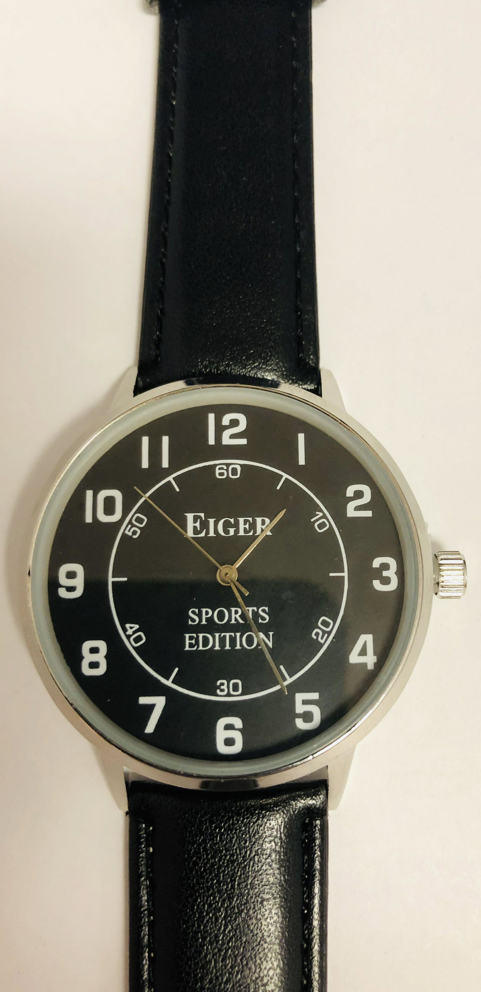 Mens Eiger Sports Edition Watch With Black & White Dial: Mens Eiger Sports Edition Watch With Black & White Dial on a Faux leather band. Watch has a new battery , watch is working and is new in plastic.