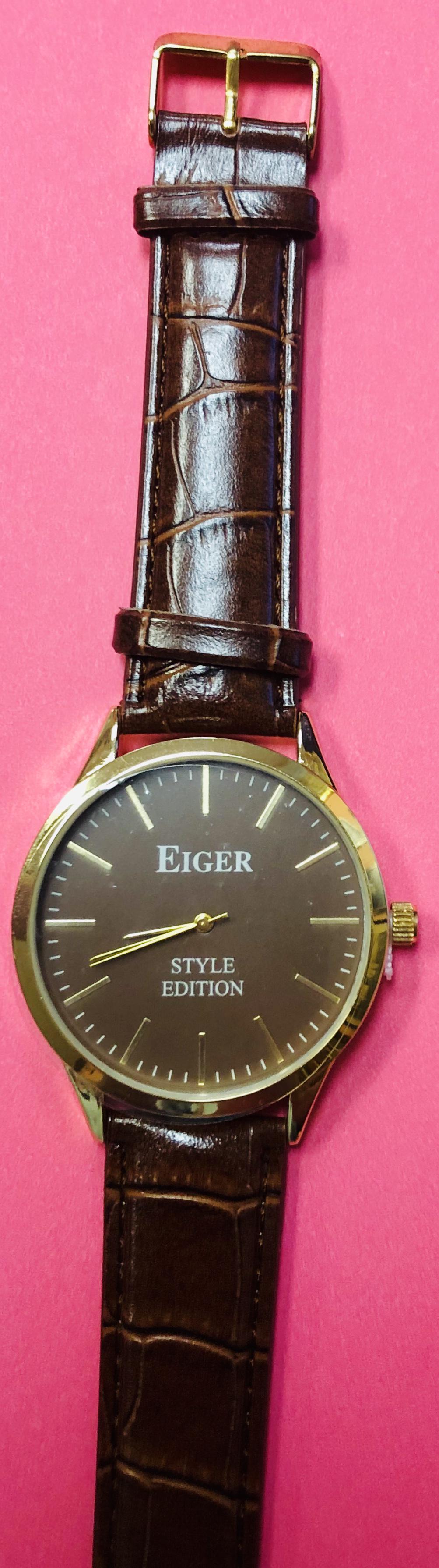 Mens 42 mm Eiger Style Edition Gold Tone Watch: Mens 42 mm Eiger Style edition gold tone watch with a faux brown leather band . Brand new battery and in original wrapping.